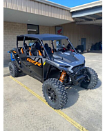 2024 RZR 1000 XP 4 Premium conquering a rocky trail