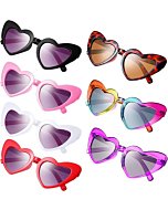 Kids wearing heart-shaped sunglasses in various colors