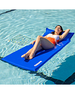 Adult relaxing on a self-inflating pool float in a pool.