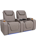  A couple is comfortably relaxing in reclining Seatcraft Muse theater seats with powered headrests and lumbar support.