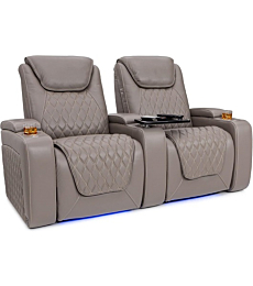  A couple is comfortably relaxing in reclining Seatcraft Muse theater seats with powered headrests and lumbar support.